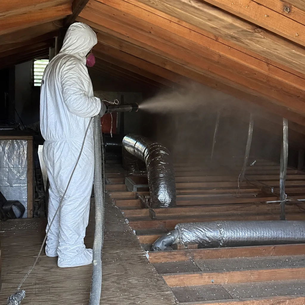 Technician in protective gear performing professional attic cleaning and rodent proofing. in Santa Monica, CA